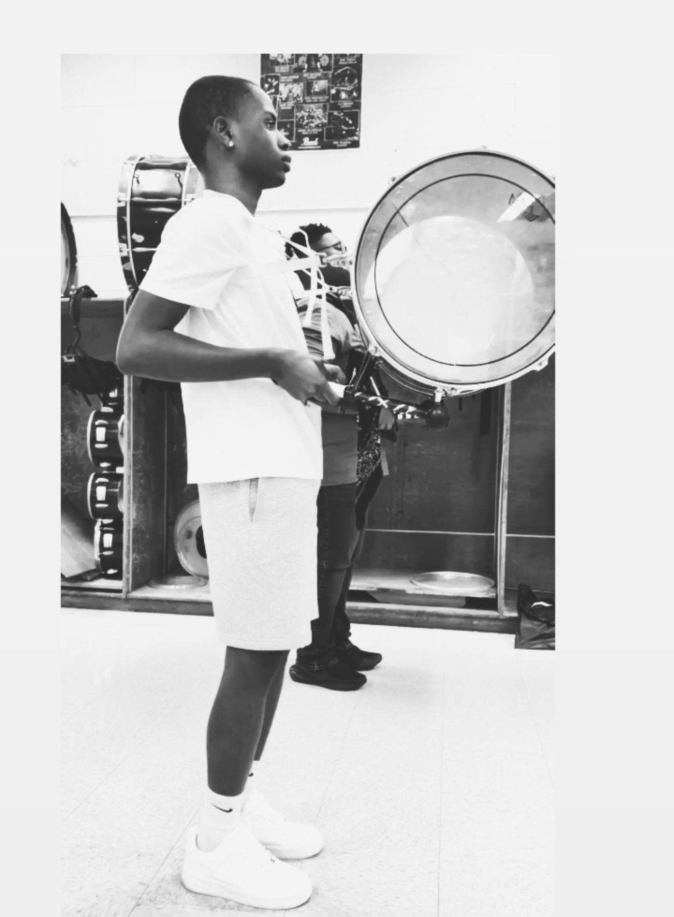 TJ playing bass drum in his high school marching band